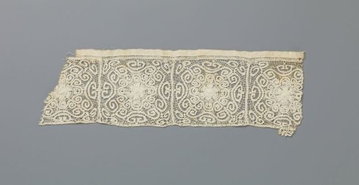 Strip of needle lace with scroll bands forming a sun