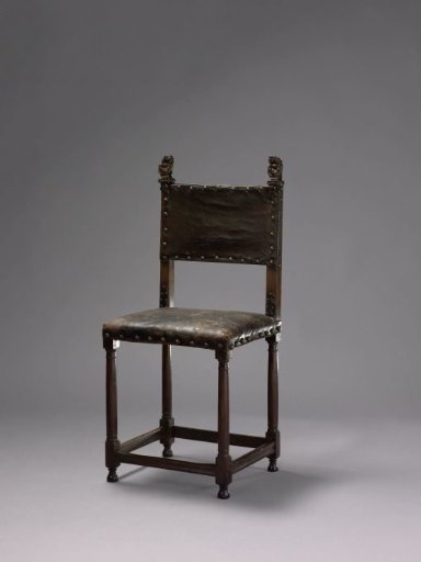 Rosewood armchair upholstered in calfskin. Columnar legs with four stretchers; rear stiles crowned by lion supporters.
