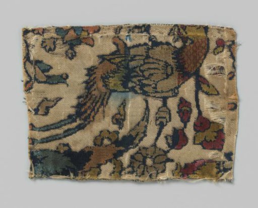 Fragment of a silk Persian textile with a pheasant among flowers and leaves
