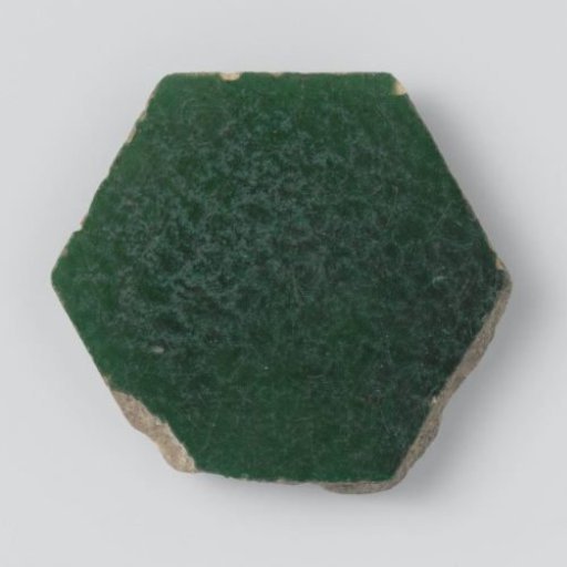 Hexagonal tile with a green glaze and inscription