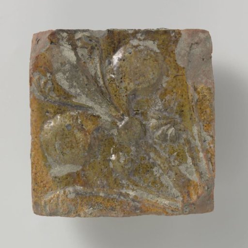 Tile decorated with a lily in relief