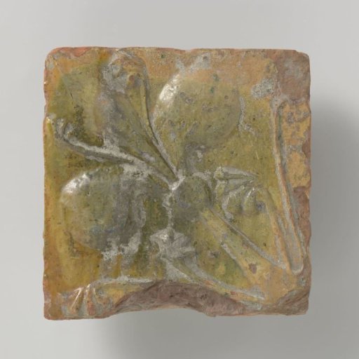 Tile decorated with a lily in relief