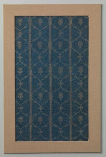 Fragment of silk satin with a pattern of vertical bands of interlinked pointed ovals, each containing a flower figure in the center