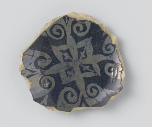 Fragment of a bowl with lily-shaped floral scrolls