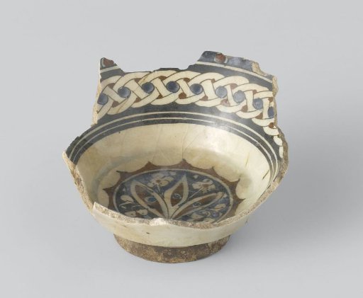 Fragment of a bowl with a flowering plant in a medallion