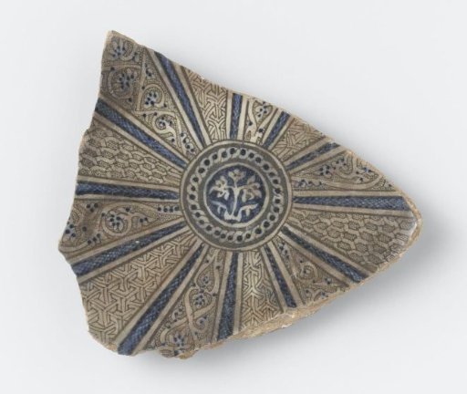 Fragment of a dish with a flowering plant, floral scrolls and geometrical patterns