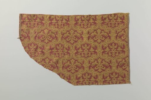 Fragment of red and yellow silk weave with stylized floral and leaf motifs