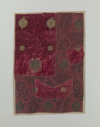 Fragment of red velvet brocade with a floral motif pattern