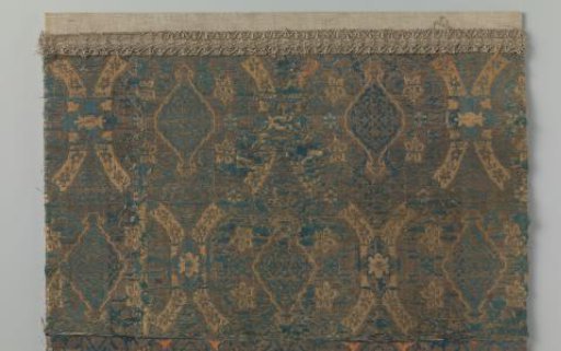 Fragment of silk lampas with a pattern including pomegranates, floral scrolls, and geometric motifs