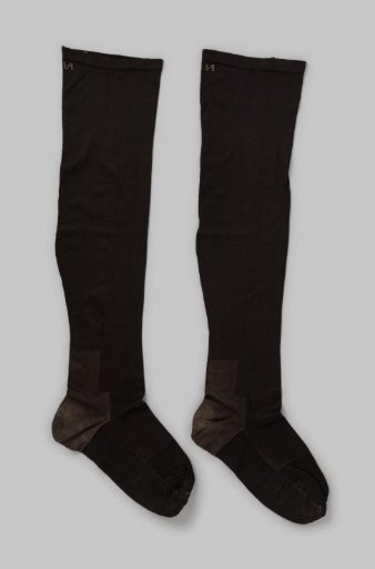 Stocking knitted of plain black shiny cotton, with woolen heels