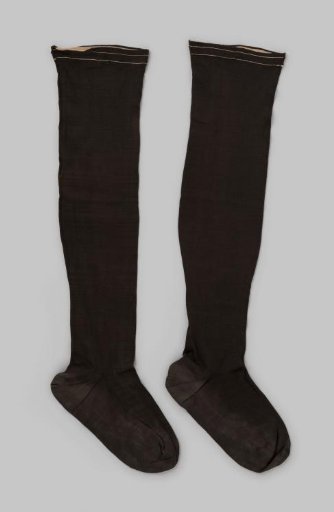 Stocking of brown-black glossy cotton with a narrow vertical stripe on the heel ending in an acorn-shaped motif and two beige stripes in the narrow border