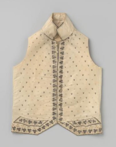 Vest with high collar of white silk, decorated with embroidery of light yellow silk, silver sequins and silver thread.
