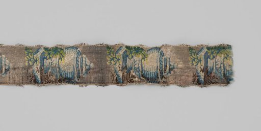 Ribbon of silk brocade; on a silver-colored ground is a repeating pattern of a covered vase with foliage, in blue, cream and green