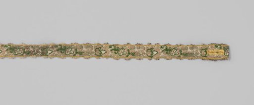 Sash of silk brocade; on a white ground a continuous pattern of a leaf vine is applied in green, pink and silver