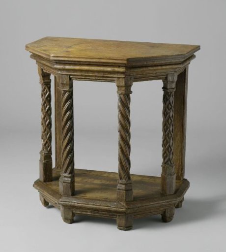 Wall table with under-shelf, on a half-octagonal plan, decorated with moulded framing and interlaced bandwork. The four front posts in the form of columns with capitals and bases