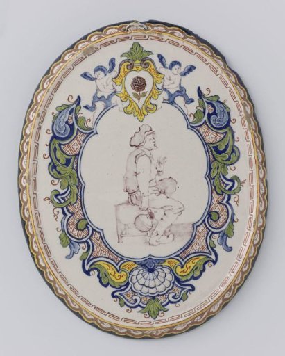 Plate, oval, polychrome painted with a seated farmer within a lambrequin border