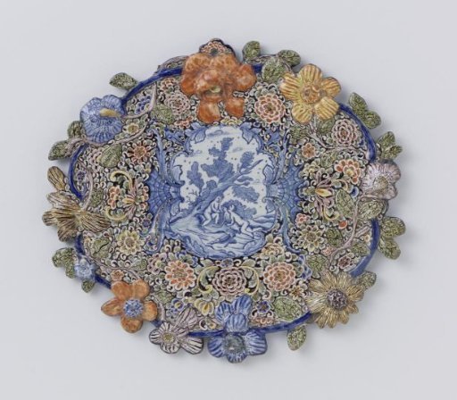 Plate, oval, with a border of multicoloured flowers in relief around a blue-painted landscape with figures