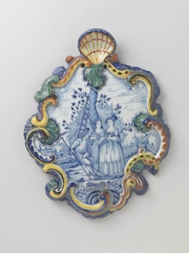 Plate in cartouche shape with a landscape in blue with three figures under a tree, within a multicoloured flower border