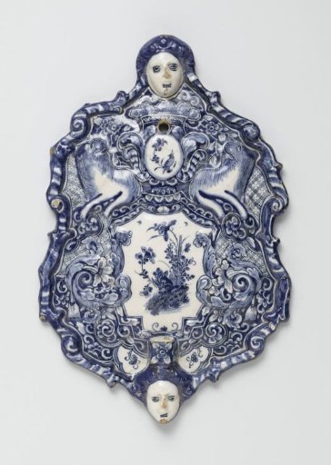Two backplates of wall sconces