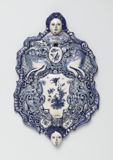 Two backplates of wall sconces