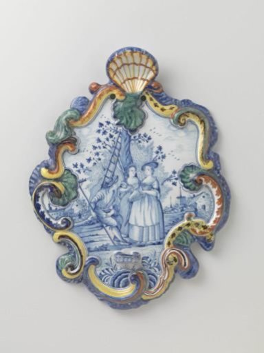 Plate, cartouche-shaped, with a landscape in blue with three figures and a tree within a multicoloured flower border