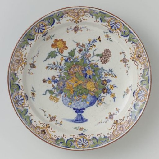 Plate with border of lambrequins and shells; on the flat a vase with flowers