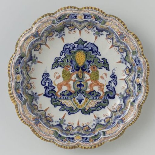 Bowl with scalloped rim; on the flat a heraldic ornament
