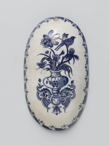 Oval brush-back of faience