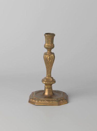 Bronze candlestick on a square base with trophies, weapons, and musical instruments