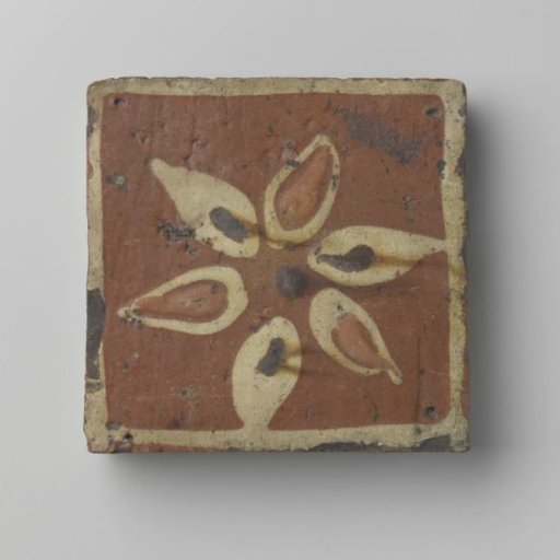 Tile, square, of earthenware glazed with lead glaze on the front and decorated with a border of white slip, within which a star of white slip