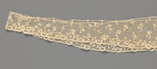 Bobbin lace engagement piece with scattered flowers and medallions in a floral border; the smallest motifs are appliques