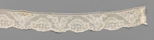 Strip of bobbin lace with a hanging triangular cartouche with a pear-shaped flower