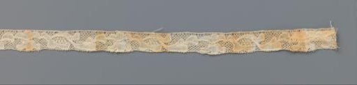 Strip of bobbin lace with a double three-petaled flower