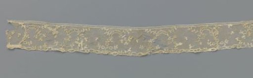 Strip of appliqué lace with a row of arches and sparse twigs