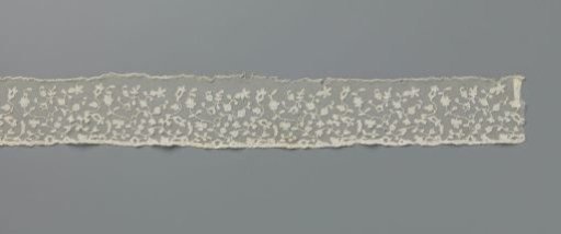 Strip of appliqué lace with twisting sparse branches and flowers