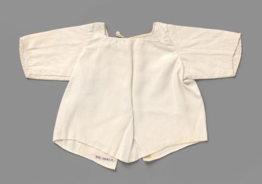 Half-shirt for a child of white linen, with two ribbon ties at the top