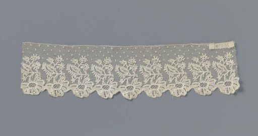 Strip of bobbin lace with hanging flower and star-shaped small flowers