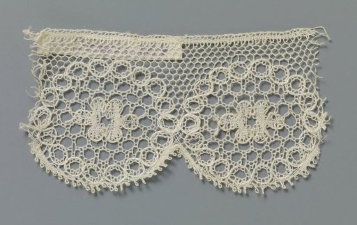Strip of bobbin lace with linked circles with a rosette flower in the center