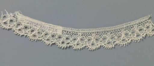 Strip of bobbin lace with three-leaf clovers