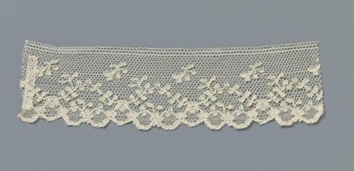 Strip of machine-made lace with regularly wavy vine with small leaves