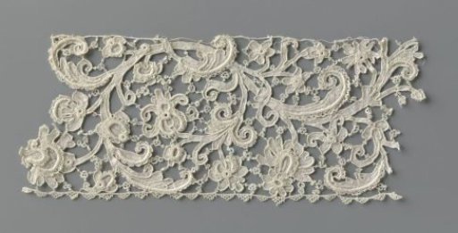Strip of needle lace with wavy, curling vine and various flowers