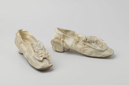 White satin glove with bows on the vamp, square toe, and three-quarter heel