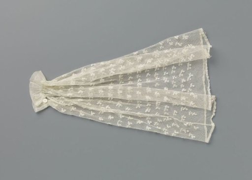 Under-sleeve of appliqué lace with a scattered pattern of an oval flower on a stem with two leaves