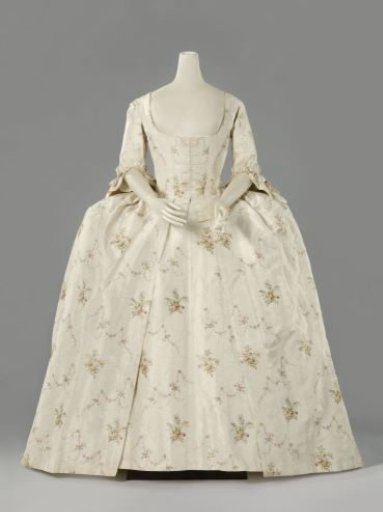Skirt with smooth center panel and pleated sides with space for panier, of cream silk with stripes, floral vines, links, embroidered multicolored bouquets and garlands.
