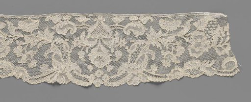Strip of needle lace with wide U-shaped field around hanging heart-shaped flower vase and acanthus leaves