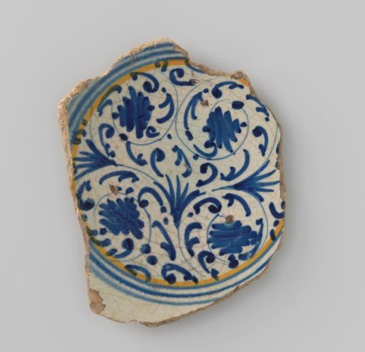 Fragment of a plate, painted in multiple colors with stylized leafy tendrils and concentric circles