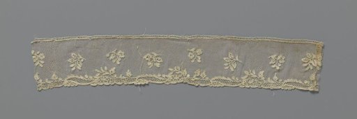 Strip of needle lace with scattered flower branches