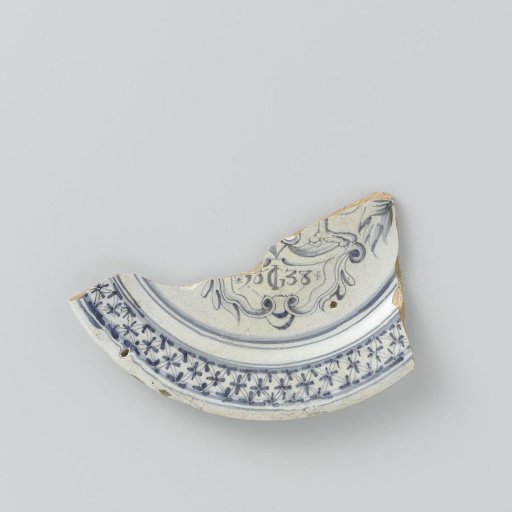 Fragment of a plate, painted in blue under the glaze with a cartouche bearing the monogram IG and the date 1638