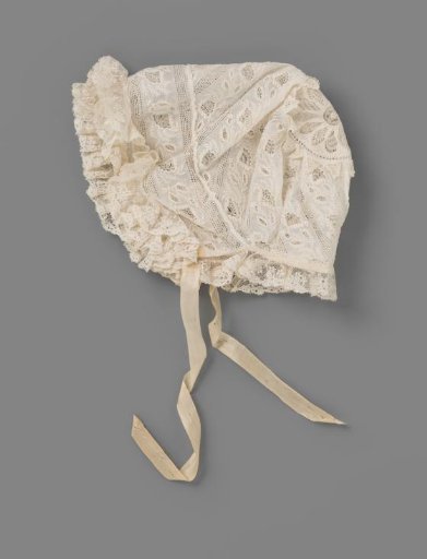 Children's cap of white net fabric decorated with white work and fils tirés, trimmed with strips of Mechelen lace