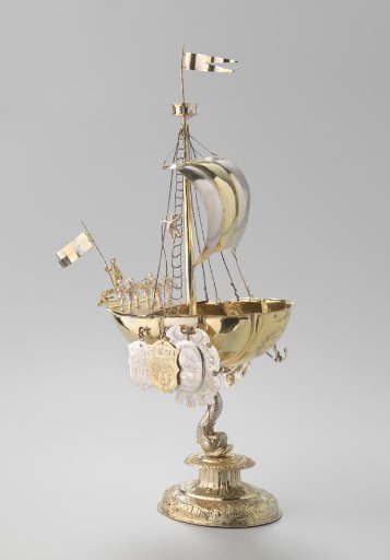 Ship-shaped drinking cup of gilded silver carried by a dolphin. The ship is rigged with mast, rigging and sail and is manned by 12 men.